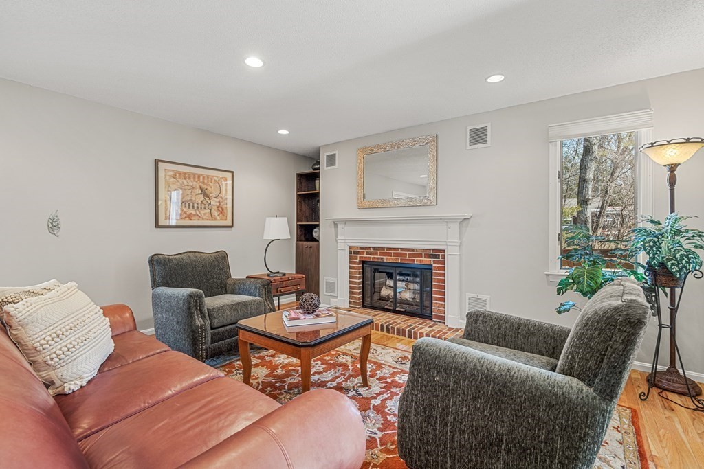7 Coltsway, Unit 7 Wayland, MA 01778 - Photo 10 of 26 a living room with furniture potted plant and a fireplace
