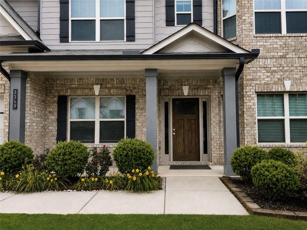 3359 Elkhorn Ridge Run Dacula, GA 30019 - Photo 2 of 35 a front view of a house with a yard and potted plants