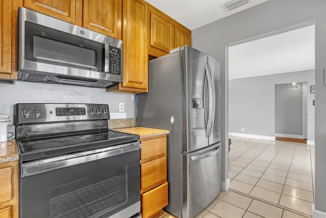 a kitchen with granite countertop a sink and cabinets