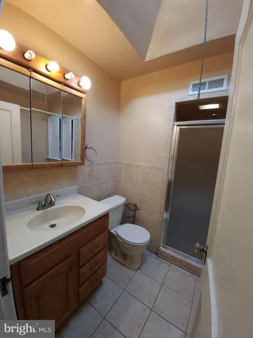 a bath tub sitting next to a white sink and vanity