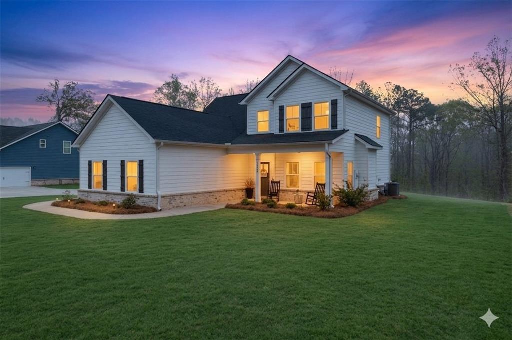 171 Strickland Loop Forsyth, GA 31029 - Photo 3 of 25 a view of a house with patio and garden