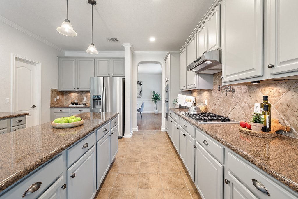 11129 Bastogne Loop Austin, TX 78739 - Photo 12 of 40 The soft neutral tones throughout the kitchen make it feel calm, clean, and incredibly versatile. Whether your style leans modern, classic, or cozy, this space works beautifully with all of it.