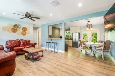 a living room with furniture and a wooden floor