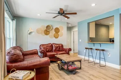 a living room with furniture and a wooden floor