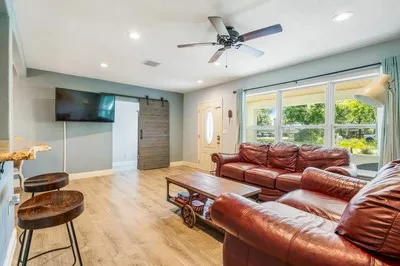 a living room with furniture and a flat screen tv