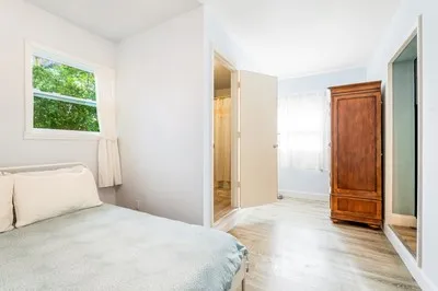 a bedroom with a bed and a window