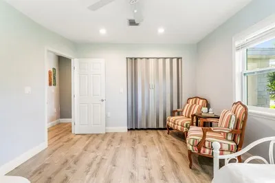 a view of a bedroom with furniture and windows