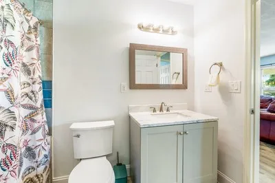 a bathroom with a toilet sink and mirror