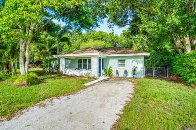a front view of a house with a yard and porch