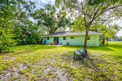 a backyard of a house with garden and outdoor seating