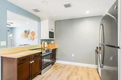 a spacious bathroom with a granite countertop sink mirror vanity and bathtub