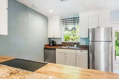 a kitchen with a sink cabinets and refrigerator
