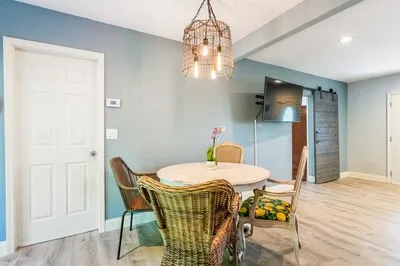a view of a dining room with furniture and chandelier