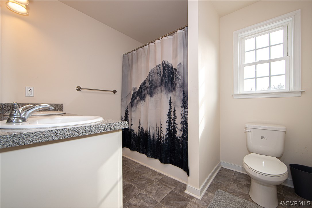 18951 Lundys Road Dinwiddie, VA 23841 - Photo 11 of 27 a bathroom with a granite countertop sink toilet and shower