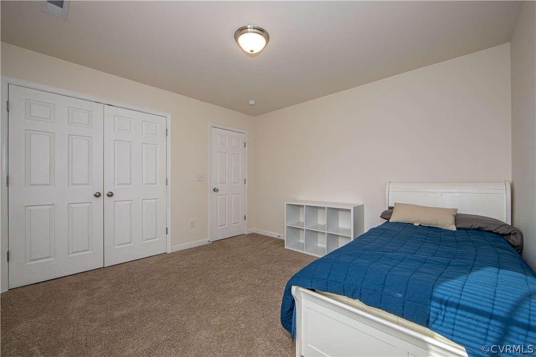 18951 Lundys Road Dinwiddie, VA 23841 - Photo 16 of 27 a bedroom with a bed and a closet