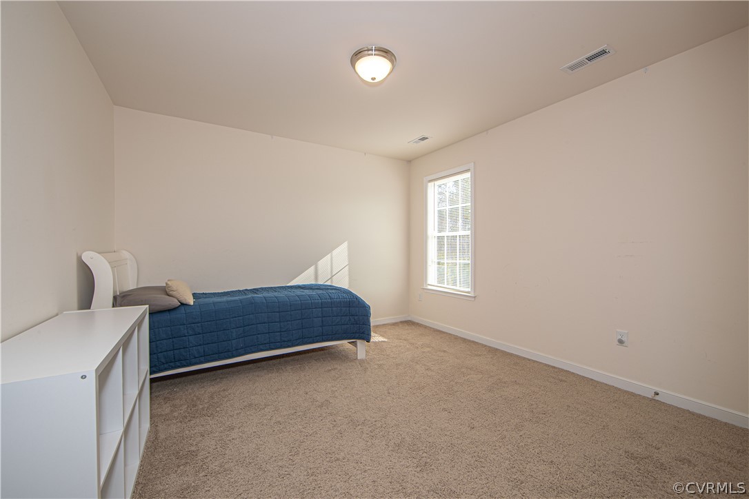 18951 Lundys Road Dinwiddie, VA 23841 - Photo 17 of 27 a bedroom with a bed and window