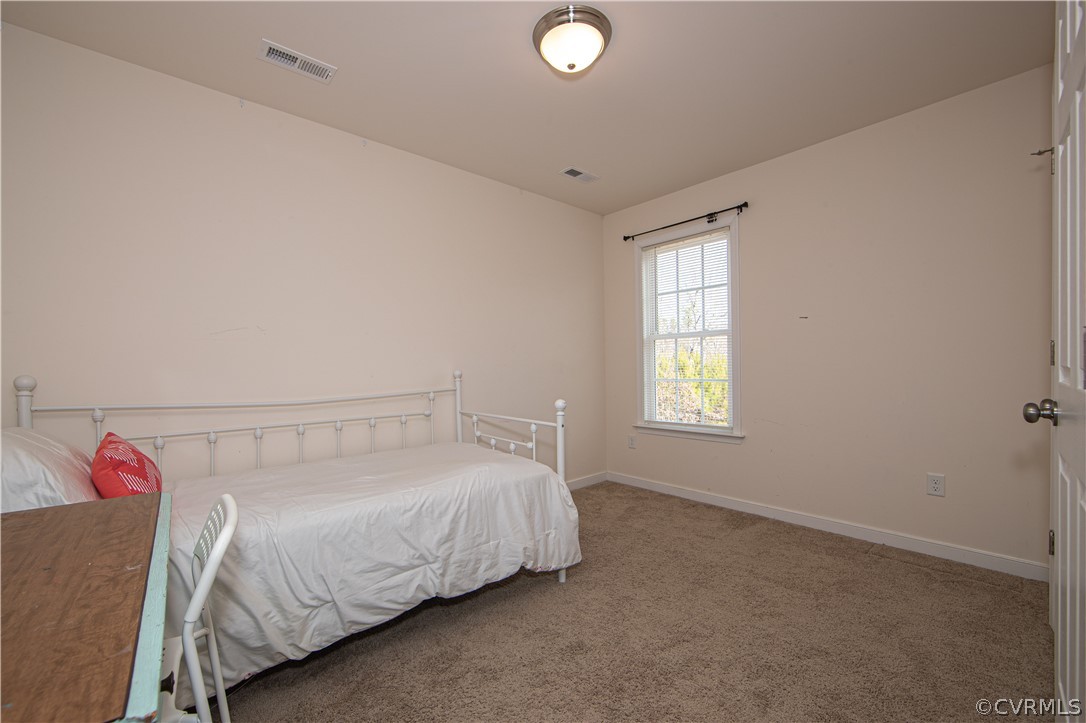 18951 Lundys Road Dinwiddie, VA 23841 - Photo 18 of 27 a bedroom with a bed and a window