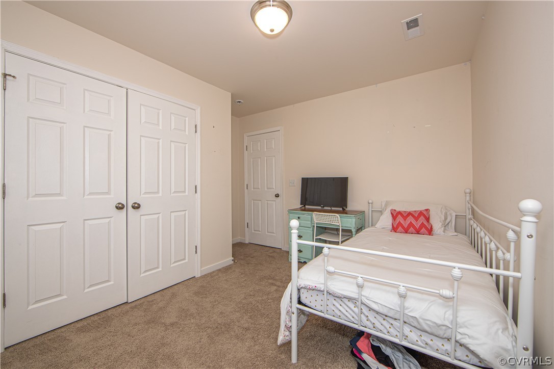 18951 Lundys Road Dinwiddie, VA 23841 - Photo 19 of 27 a bedroom with a bed and a flat screen tv