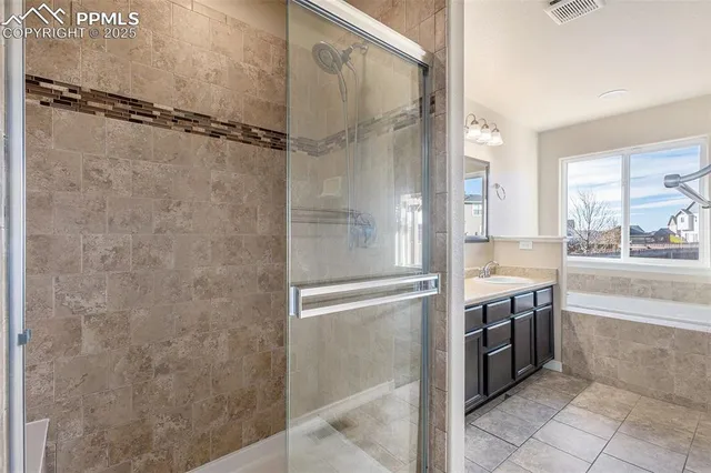 a bathroom with a granite countertop shower mirror and a sink