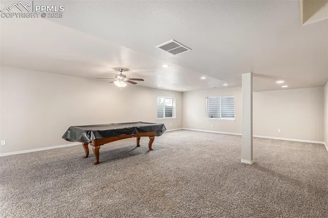 a view of a livingroom with furniture and a ceiling fan