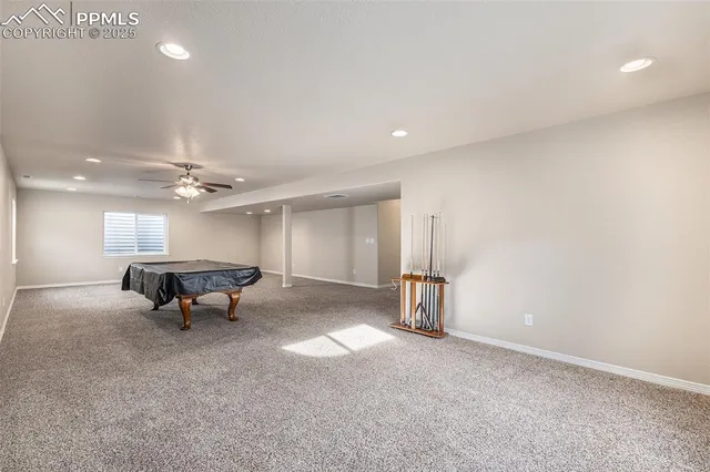 a living room with furniture and a ceiling fan