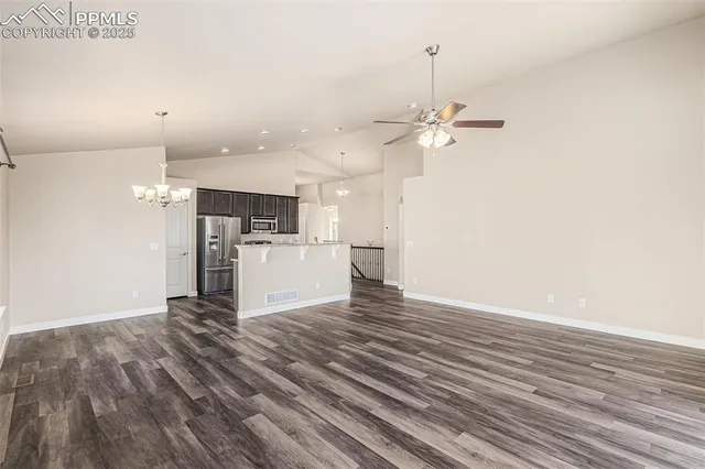 a view of a kitchen with wooden floor and a ceiling fan