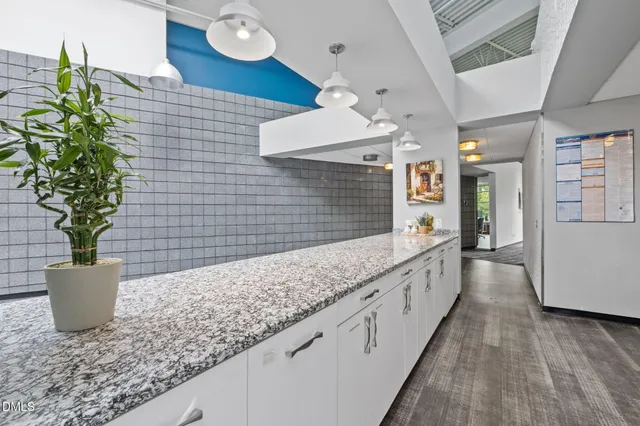 a large kitchen with a large window and stainless steel appliances