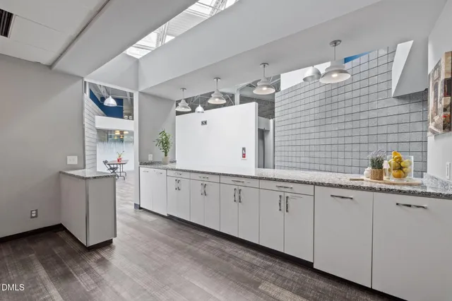 a kitchen with a refrigerator sink and cabinets