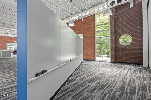 a view of a bedroom with a bed and window