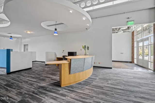 a view of a living room with kitchen countertops and wooden floor