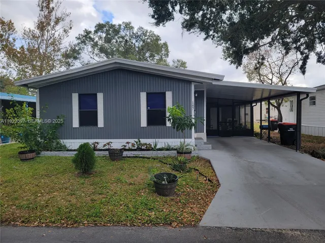 a view of a house with pool yard and chairs