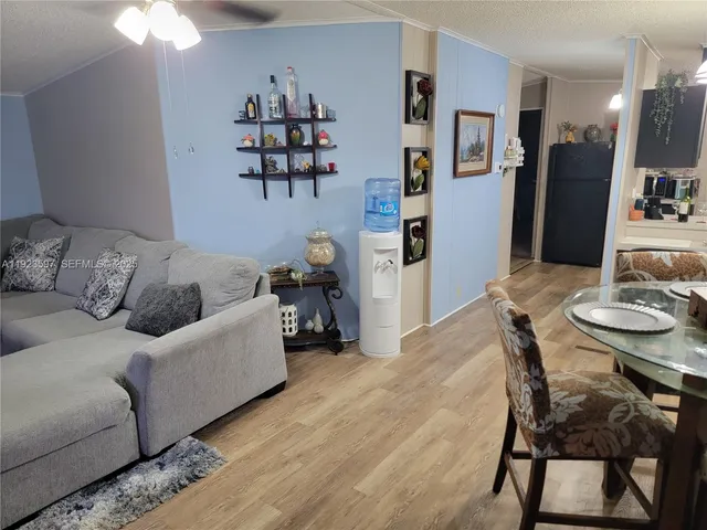 a living room with furniture and a dining table