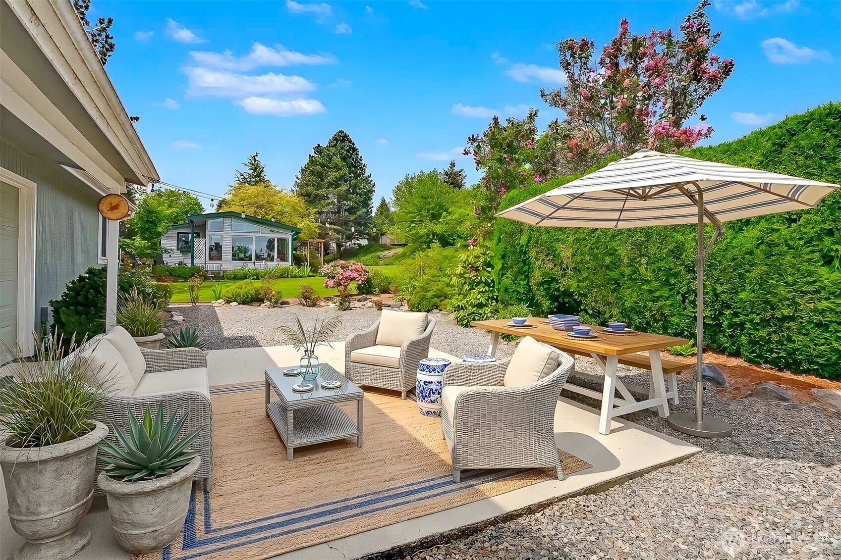 905 243rd Street Southwest Bothell, WA 98021 - Photo 30 of 37 a roof deck with table and chairs under an umbrella with potted plants
