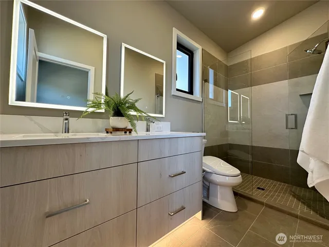 a bathroom with a sink toilet and mirror