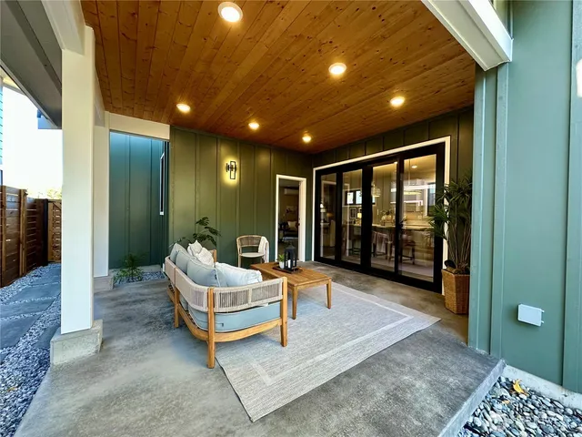 a spacious bedroom with a bed and glass window