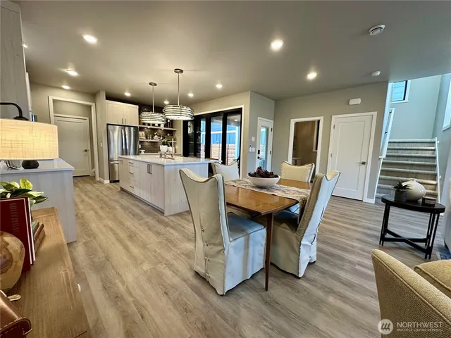 a dining room with furniture and wooden floor