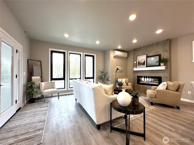 a living room with furniture fireplace and a wooden floor