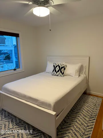 a bed sitting in a bedroom next to a window