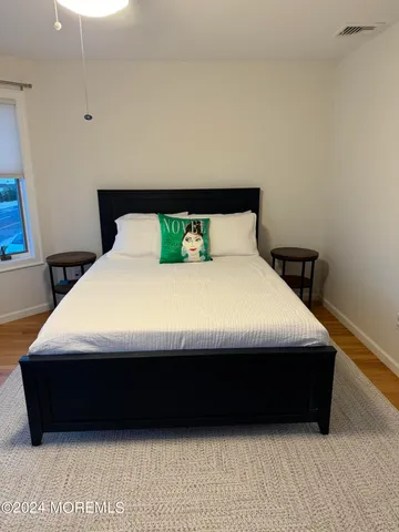 a large bed sitting in a bedroom next to a window