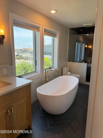 a view of a bathroom with a tub and sink