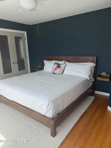 a bedroom with a bed and a mirror