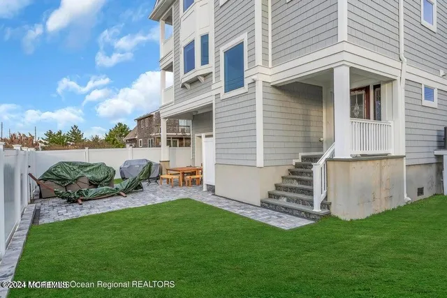 a backyard of a house with table and chairs
