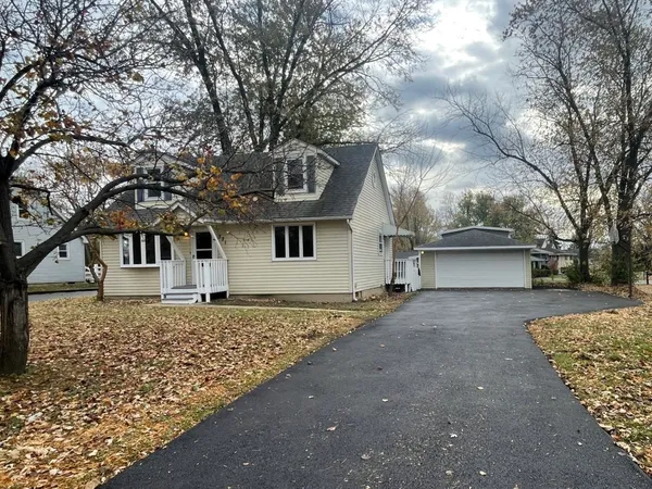 front view of a house with a large trees