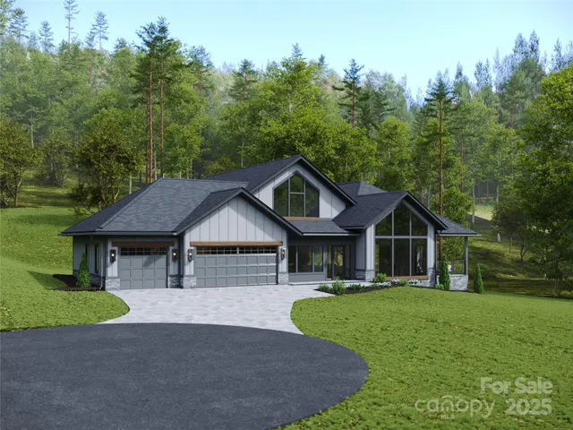 a front view of a house with a yard and trees