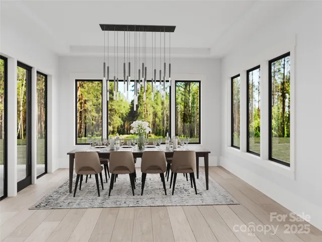 a dining room with furniture and large windows