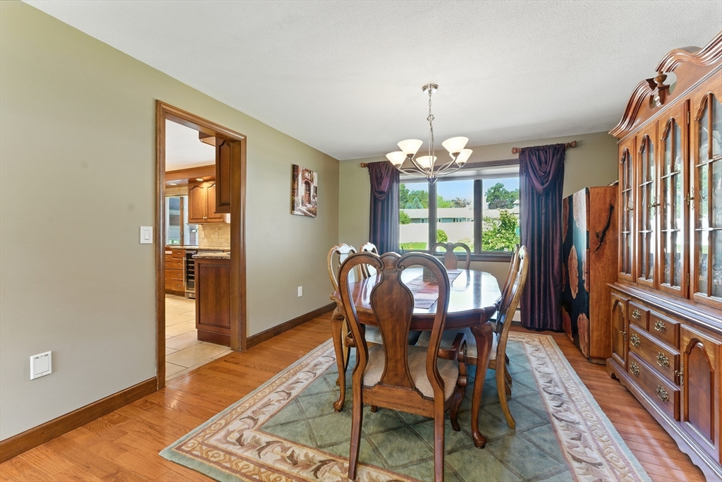 51 Newcrest Street Ludlow, MA 01056 - Photo 19 of 38 a dining room with furniture a chandelier and wooden floor