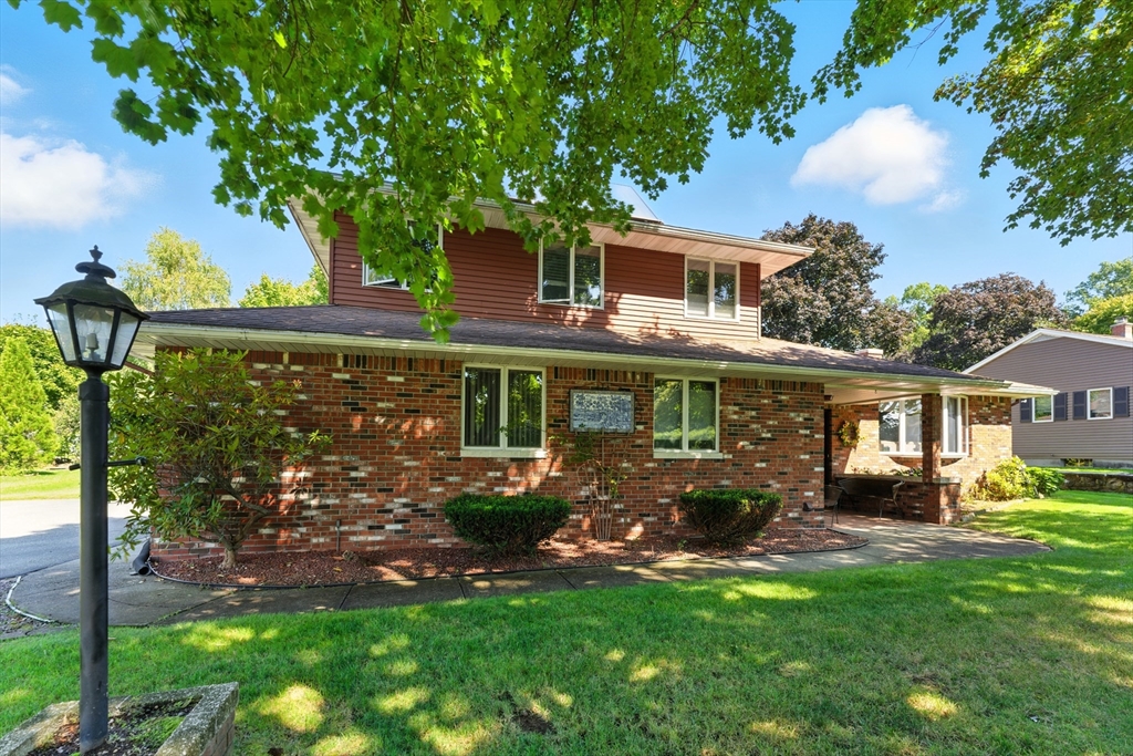 51 Newcrest Street Ludlow, MA 01056 - Photo 2 of 38 a front view of a house with a garden
