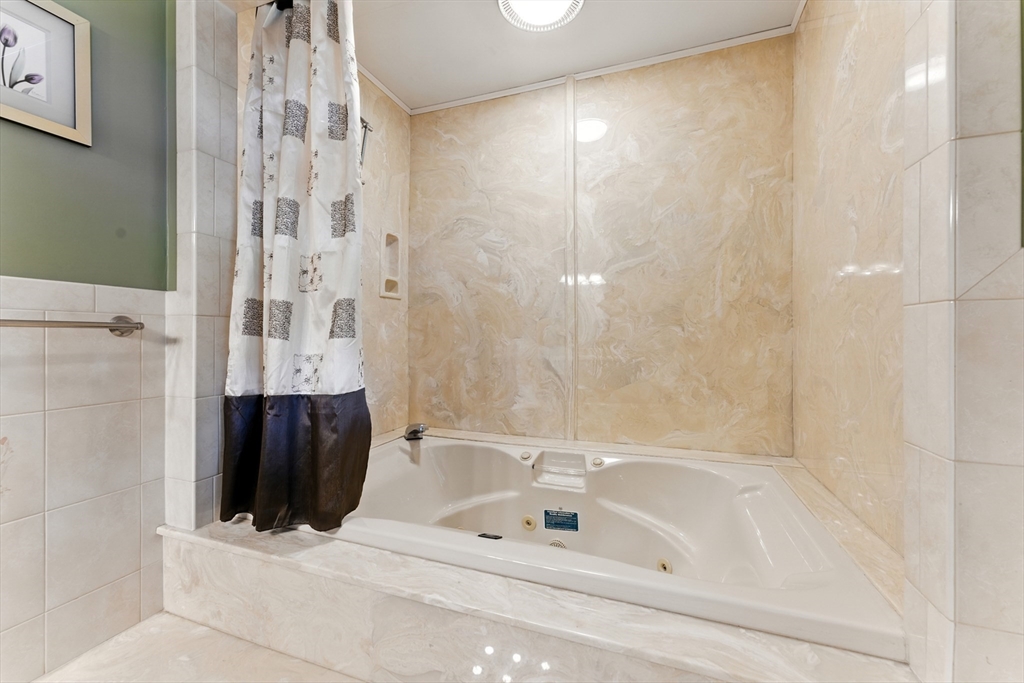 51 Newcrest Street Ludlow, MA 01056 - Photo 30 of 38 a bathroom with a bathtub and a shower