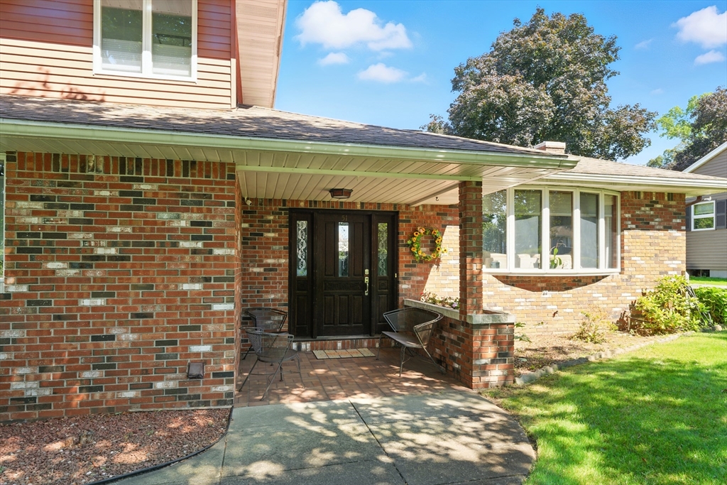 51 Newcrest Street Ludlow, MA 01056 - Photo 3 of 38 a front view of a house with a yard