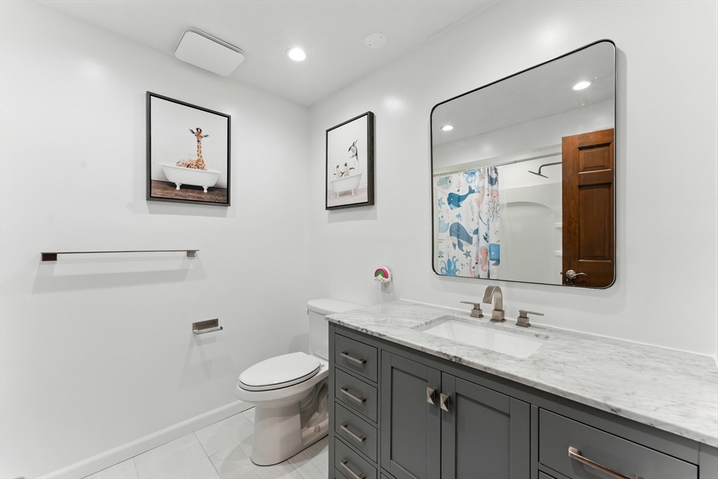 51 Newcrest Street Ludlow, MA 01056 - Photo 31 of 38 a bathroom with a toilet a sink and mirror